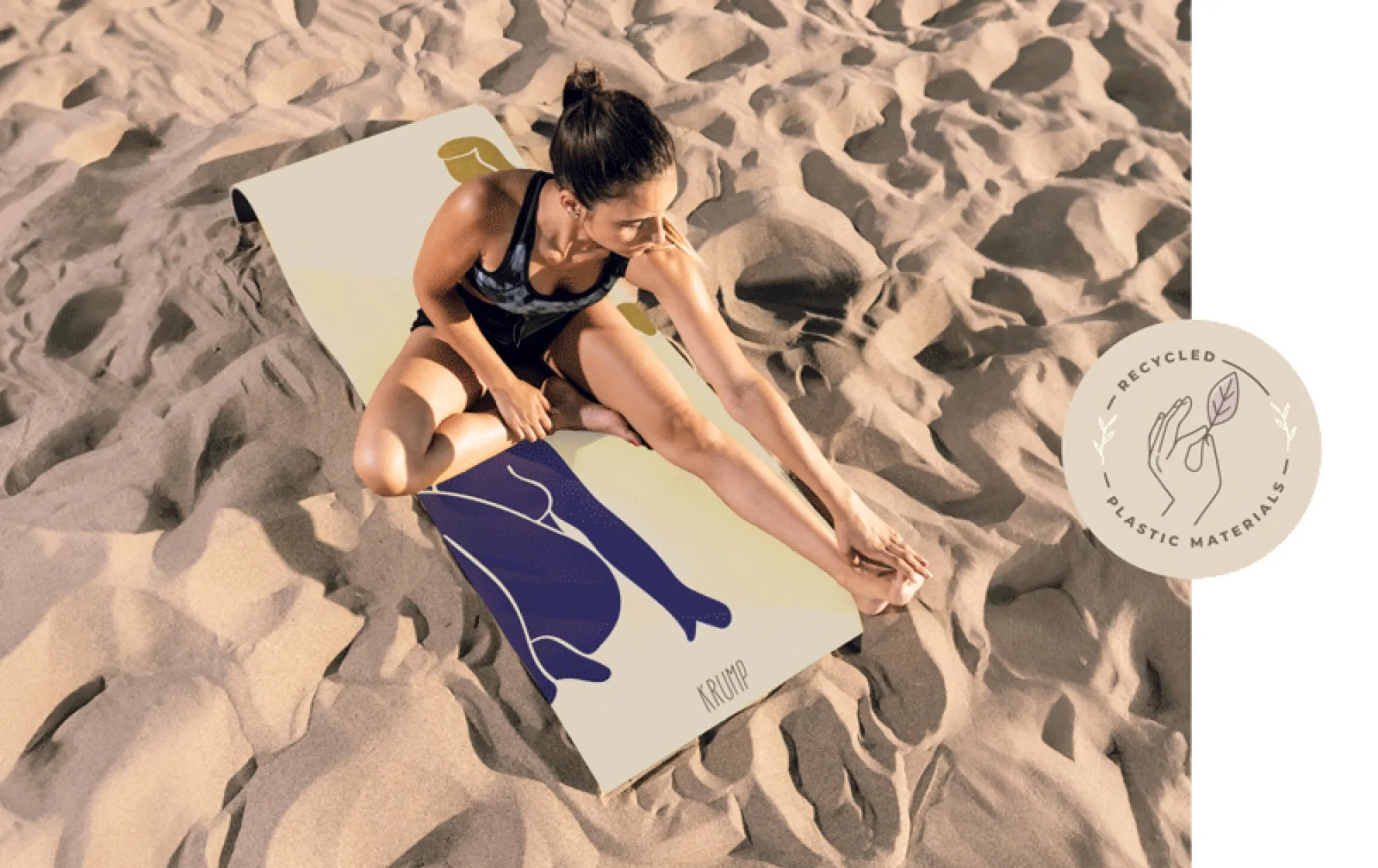 Woman stretching on a KRUMP Pilates mat on sand dunes