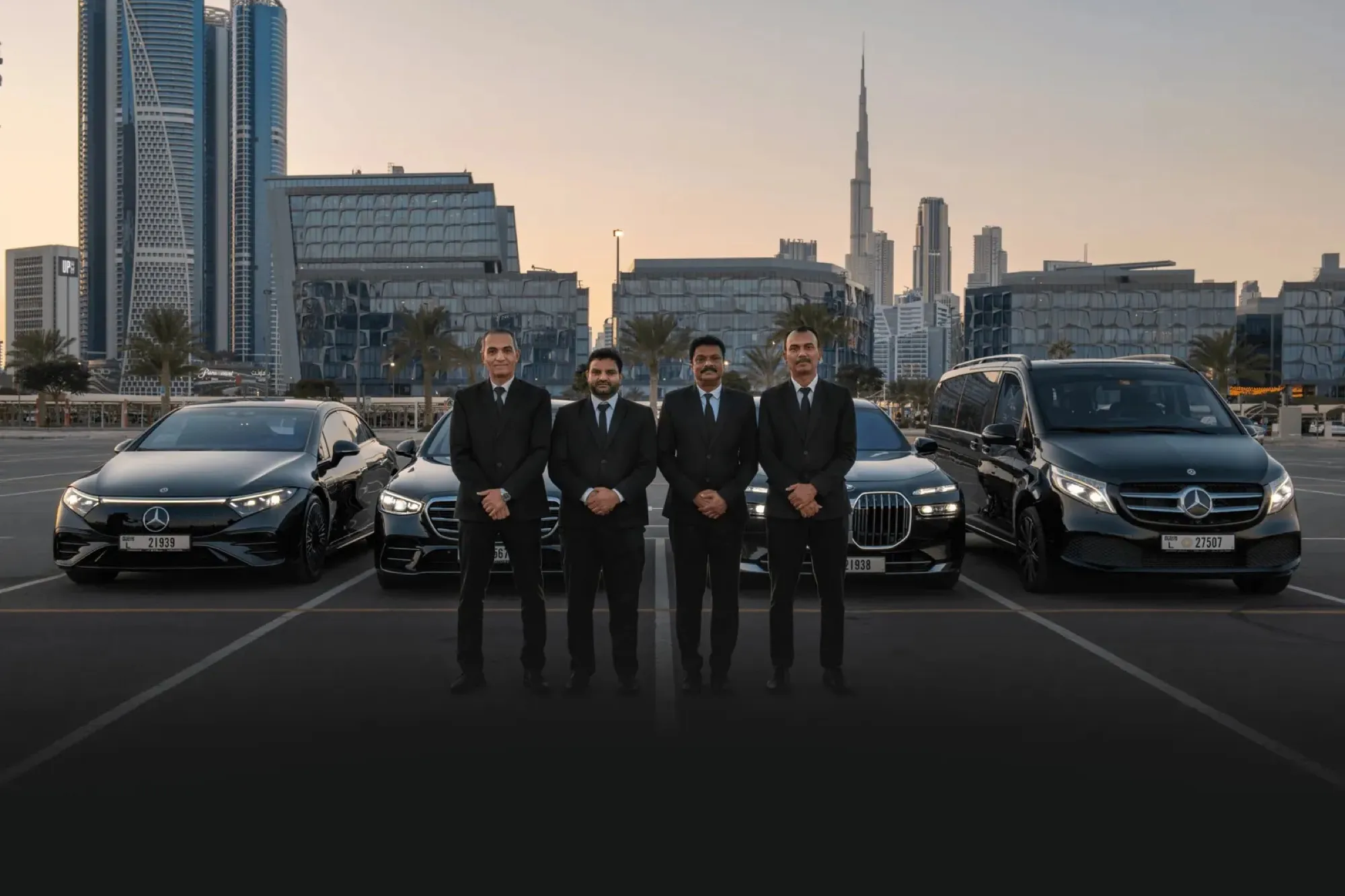 Chauffeur team lined up with the fleet, Dubai skyline behind