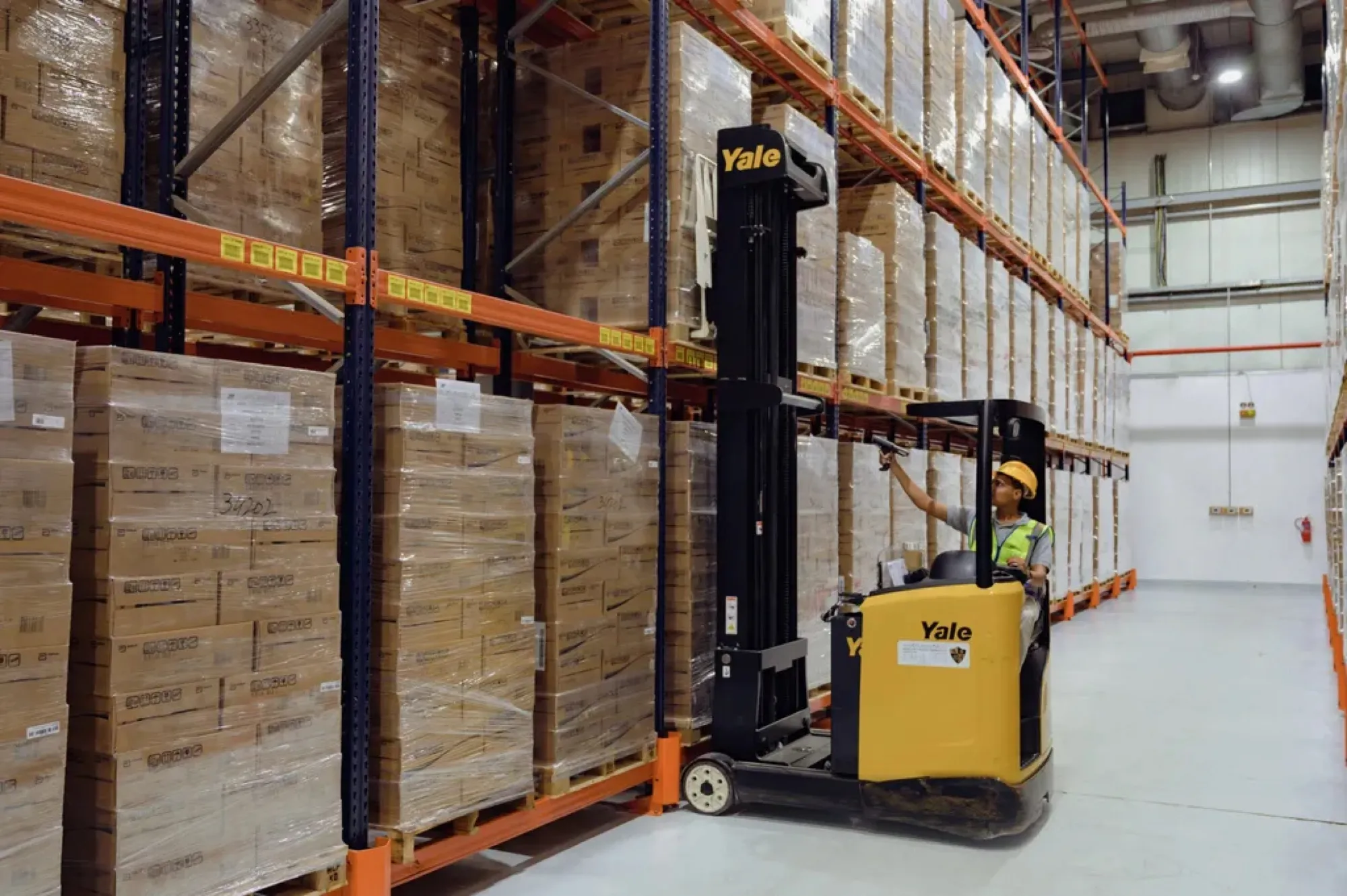 Reach truck working the racks