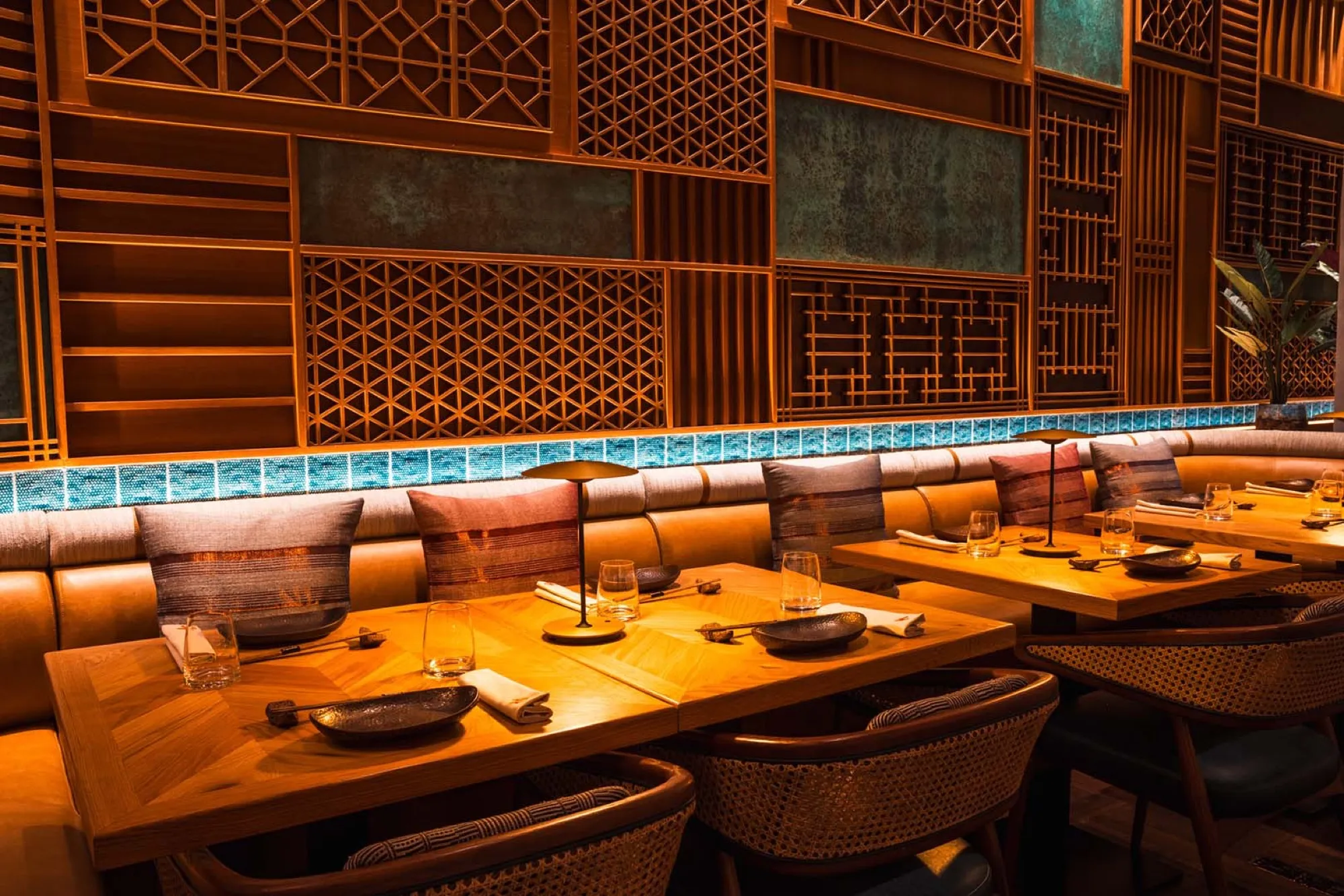 Dining room with carved lattice walls in warm light