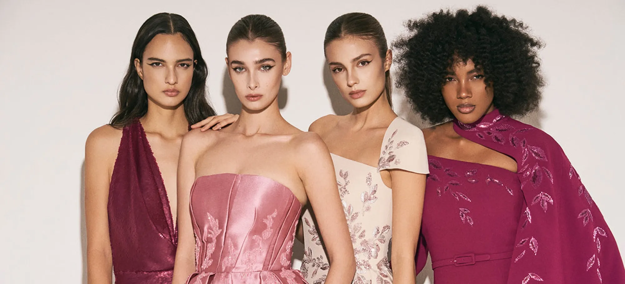 Four models in couture gowns